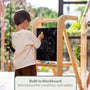 A child draws on the built-in blackboard of a wooden TP Active-Tots Pikler Style Wooden Helper Tower - FSC® certified toddler tower.