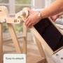 In a bright room, a child attaches the TP Toys TP Active-Tots Pikler Style Wooden Easel Play Accessory (FSC® certified) to a light wooden easel. The “Easy to attach” label makes it an ideal addition to any kid’s creative space.