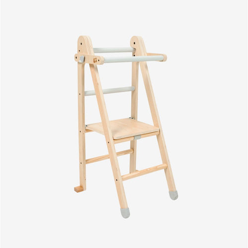 The TP Toys TP Active-Tots Pikler Style Wooden Folding Helper Tower—crafted from FSC® certified wood—features gray accents, two sturdy steps, and safety rails thoughtfully designed for children. Against a plain white background, this stylish kids step stool offers both safety and support for little ones reaching new heights.