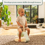 A young child sits on the TP Toys TP Active-Tots Pikler Style Toddler Bouncer—crafted from FSC® certified wood—in a bright living room. Text above reads, Encourages gross motor skill development through active bouncing.