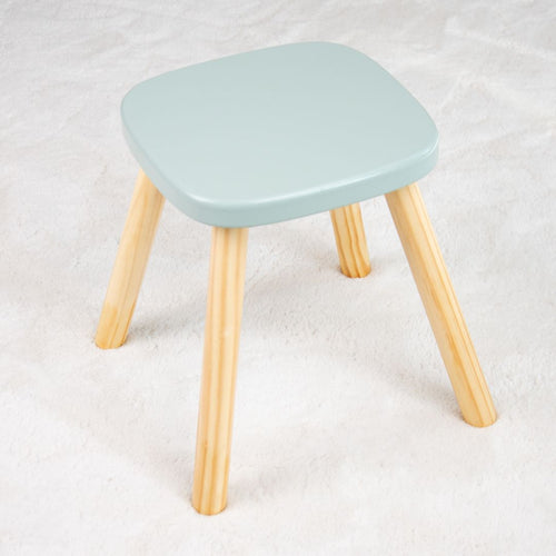 The TP Active-Tots Pikler Style Wooden Stool by TP Toys features four light-colored legs and a pale green square seat—FSC® certified, perfect child-safe furniture for any playroom.