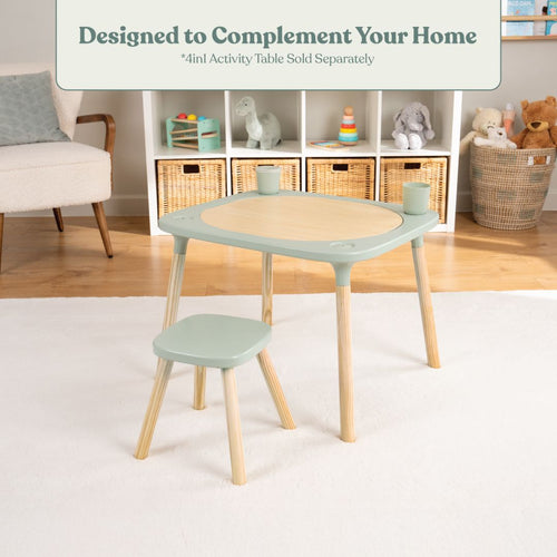 A small pastel activity table with a TP Toys Active-Tots Pikler Style Wooden Stool (FSC® certified) sits on a white rug in a cozy, child-friendly room with shelves, baskets, and toys in the background.