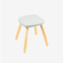 The TP Toys TP Active-Tots Pikler Style Wooden Stool - FSC® certified features a light gray square seat and four natural wood legs, shown against a plain white background—an ideal piece of eco-friendly toddler furniture for your home.