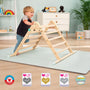 A toddler climbs the TP Toys TP Active-Tots Pikler Style Wooden Climbing Triangle (FSC® certified) on a play mat in a bright room. Four award badges highlight this engaging Montessori indoor climbing toy for toddlers.