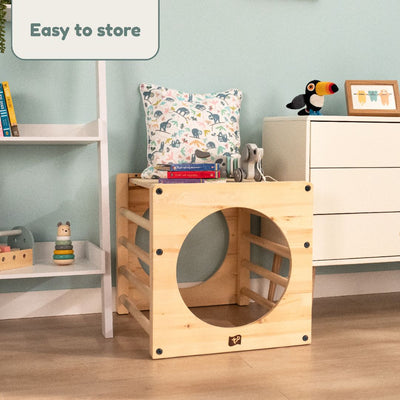 The TP Toys Active-Tots Pikler Style Wooden Climbing Cube With Play Easel (FSC® certified) serves as a seat and storage for books, toys, or a cushion. Easy to store, it fits perfectly beside a dresser or bookshelf in any indoor play area.