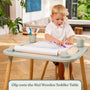 A young child sits at a table using the TP Active-Tots Play Table Paper Roll Accessory, drawing on paper pulled from the roll during creative play.