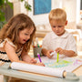 Two children use a TP Active-Tots Play Table Paper Roll Accessory to draw on a large sheet mounted on an Active Tots 4-in-1 toddler table.