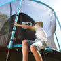 A boy climbing through the zip-free entry of a blue and black TP Genius Blue 14ft Round Trampoline with a SurroundSafe enclosure.