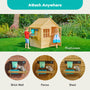 Two children play outdoors with the TP Toys TP Early Fun Mud Kitchen Playhouse Accessory, made from FSC® certified wood. Three labeled shelves are attached nearby to a brick wall, a fence, and a shed for easy organization.