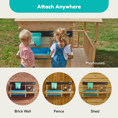 Two children enjoy the TP Deluxe Mud Kitchen Playhouse Accessory by TP Toys, a fun FSC® certified water activity station that can be mounted on a wooden playhouse, brick wall, fence, or shed.