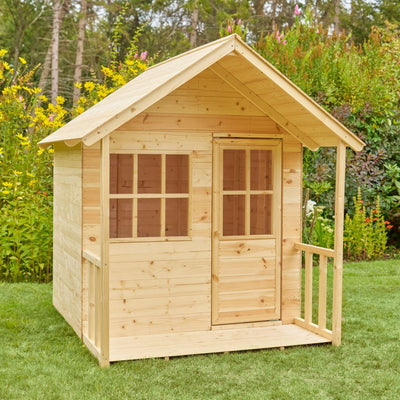 The TP Toys TP Forest Cabin Wooden Playhouse – FSC® certified, with its gabled roof, porch, windows, and door, creates the perfect garden playhouse on any lawn surrounded by plants and flowers.