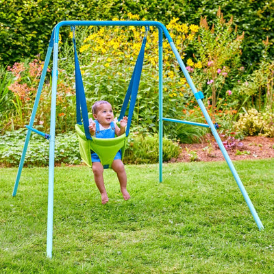 A baby enjoys gentle moments in the TP Foldaway Baby Swing by TP Toys, perfect for indoor and outdoor use.