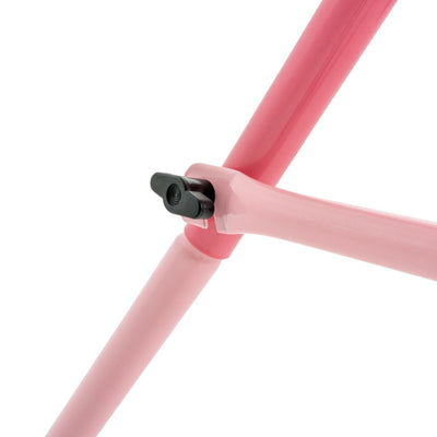 Close-up of the TP Pink Foldaway Baby Swing by TP Toys, showing its pink metal frame and black locking mechanism connecting two tubes for secure indoor or outdoor use.