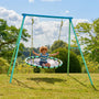 A young child enjoys the TP Toys TP Giant Nest Metal Swing Set in a grassy outdoor area, with trees and a cloudy sky in the background.