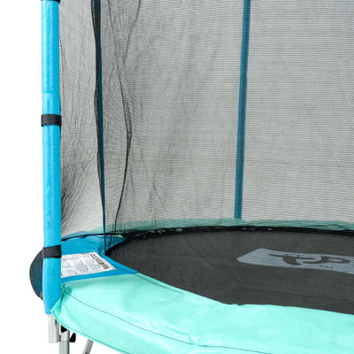 Close-up view of the TP Toys TP UP 6ft Trampoline, showing its blue padding, safety net, and a partially visible instructional label with key safety features on the edge.
