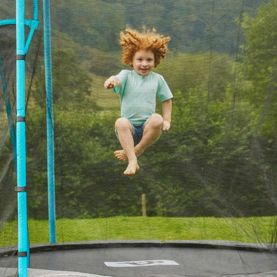 A child jumps on the TP Toys TP Up 8ft Trampoline, enjoying worry-free play with its secure, zip-free entry.