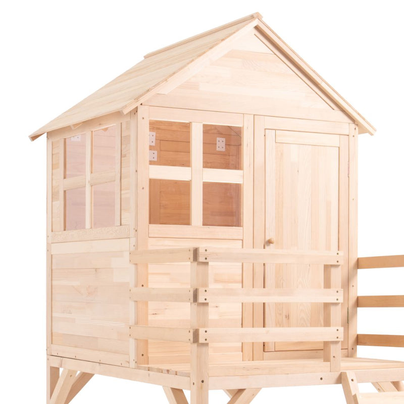 The TP Toys Buttercup Cottage Wooden Playhouse with Deck is made from unfinished light-colored FSC® certified wood and features a peaked roof, windows, door, and fenced porch for outdoor play.