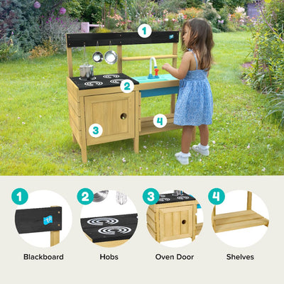 A young girl plays with the TP Toys TP Junior Chef Wooden Mud Kitchen with Working Tap & Sink, made from FSC® certified wood, featuring a blackboard, hobs, oven door, sink, and shelves on a grassy lawn.