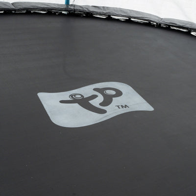 The image shows the black jumping surface of the TP Toys Up 10ft Trampoline, featuring the TP logo in the center and surrounded by protective bounce pads.