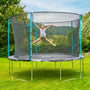 A child happily jumps with arms and legs outstretched on a TP Toys Up 12ft Trampoline, complete with safety net, enjoying active play in their grassy backyard.