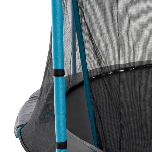 Close-up of a TP Toys TP Up 12ft Trampoline’s safety enclosure with blue padded pole, black mesh netting, and visible trampoline mat and frame.