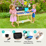 Two young children enjoy outdoor play at the TP Toys TP Little Chef Wooden Mud Kitchen – FSC® certified, featuring plant pots, a blackboard, hobs, a tap, splash tub, and shelves in a blooming garden.