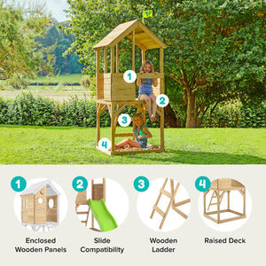 Two children enjoy the TP Toys Build Your Own TP Treehouse Wooden Play Tower—FSC® certified—with an upper deck, wooden ladder, enclosed panels, and slide on a grassy lawn with trees in the background.