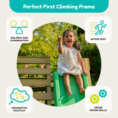 A young girl sits on the TP Toys TP Wooden Toddler Climb & Slide - FSC® certified, smiling and pointing, with icons showing balance, active play, roleplay, and motor skills benefits of this toddler play frame.