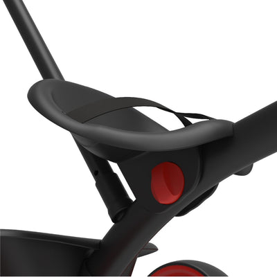 Close-up of the black seat with safety strap and red accent on the TP Toys Zoomee 2 in 1 Trike – Firecracker, set against a white background—ideal for an early fun trike or adjustable handle tricycle.