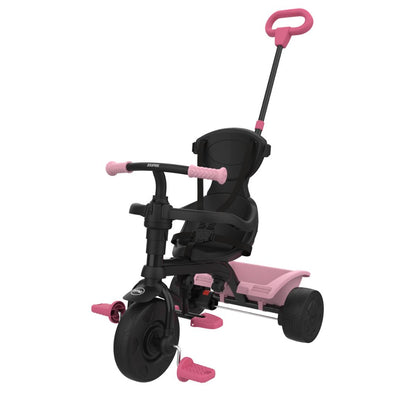 The TP Toys Zoomee 4 in 1 Trike - Unicorn Dream features a push handle, safety harness, footrests, rear storage platform, and an adjustable UV sunshade with a playful unicorn print in black and pink.
