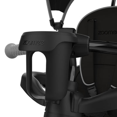 Close-up view of the TP Toys Zoomee 4 in 1 Deluxe Trike - Grey Storm, featuring a black toddler seat with safety bar, handle, adjustable seat, and “zoomee” branding on the armrest.