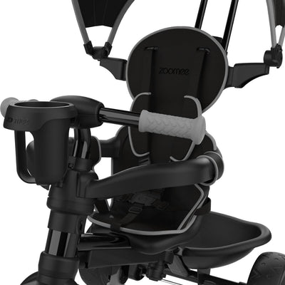 Close-up of the Zoomee 4 in 1 Deluxe Trike in Grey Storm by TP Toys, showing seatbelt, gripped handlebar, cup holder, and partial canopy.