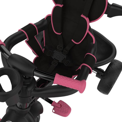 A close-up of the Zoomee 4 in 1 Deluxe Trike - Pink Dusk by TP Toys shows its secure harnessed seat, pink pedals, and rubberized handlebars.
