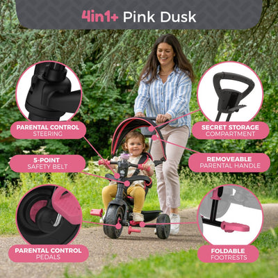 A woman pushes a child in a TP Toys Zoomee 4 in 1 Deluxe Trike - Pink Dusk, featuring a safety belt, pedals, storage compartment, parental handle, and foldable footrests.