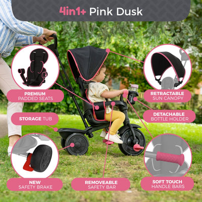 A child sits in the TP Toys Zoomee 4 in 1 Deluxe Trike - Pink Dusk, which features a padded seat, sun canopy, bottle holder, safety bar, handle grips, safety brake, and storage tub.