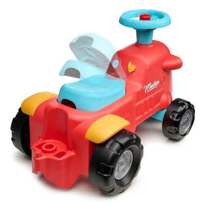 The TP Toys Falk Maurice Vintage Baby Red Tractor is a red and yellow recycled plastic ride-on with black wheels, blue seat, and steering wheel. Its raised seat back serves as a walking aid bar for toddlers learning to walk.