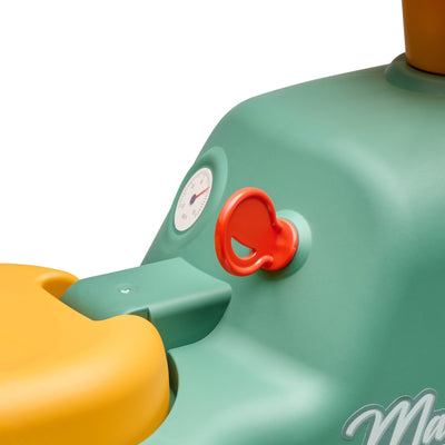 Close-up of the Falk Maurice Vintage Baby Green Tractor by TP Toys—a green and yellow recycled plastic tractor toy with a red key, small gauge, and partial printed word—ideal for little ones learning to walk.