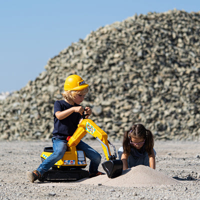 A child in a yellow helmet operates the TP Toys Falk JCB Fully Articulated Digger with opening seat, while another digs nearby in the sand—perfect for immersive construction role play.