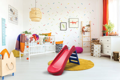 A colorful childrens bedroom with a white crib, playful wall decor, toys, and bright furnishings features the TP Toys PalPlay Red & Blue Plastic Folding First Slide—perfect for fun indoor adventures.