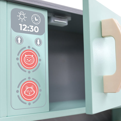 A close-up of the TP Toys Owl & Fox Wooden Imagination Kitchen Set (FSC® certified) shows a control panel with animal icons, a digital clock at 12:30, and a partially open light green door with a beige handle.