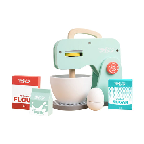 The TP Toys Owl & Fox Wooden Baking Set - FSC® certified features a toy stand mixer, mixing bowl, egg, flour, sugar, and milk cartons in pastel colors for pretend play, all displayed on a white background.