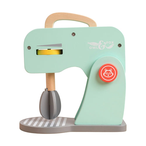 The Owl & Fox Wooden Baking Set by TP Toys is a mint green wooden toy mixer with a fox-face orange dial and mixing paddle—an FSC® certified, charming choice for any pretend play or Montessori collection.