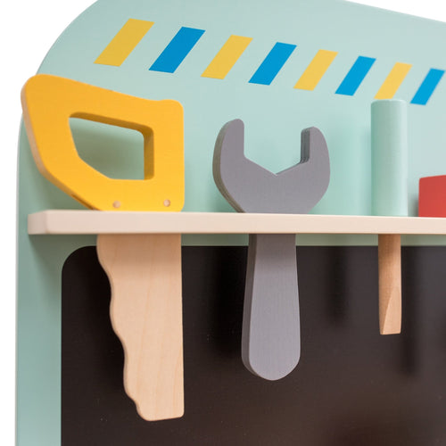 The TP Toys Owl & Fox Wooden Workbench Set—FSC® certified—features toy tools like a yellow saw, gray wrench, and green handle on a small shelf, ideal for pretend play on any Montessori bench against a striped light green background.