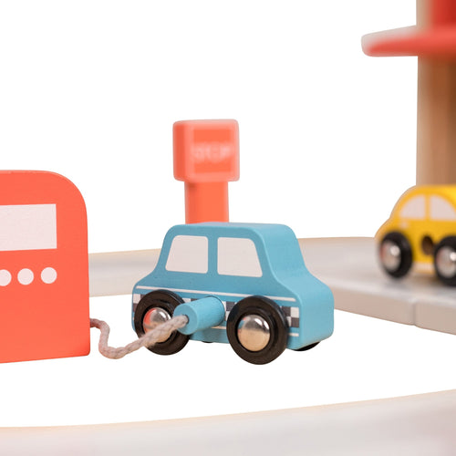 The Owl & Fox Wooden Multi-storey Garage with Vehicle Transporter by TP Toys, made from FSC® certified wood, includes vehicles and accessories—perfect for inspiring creative pretend play.