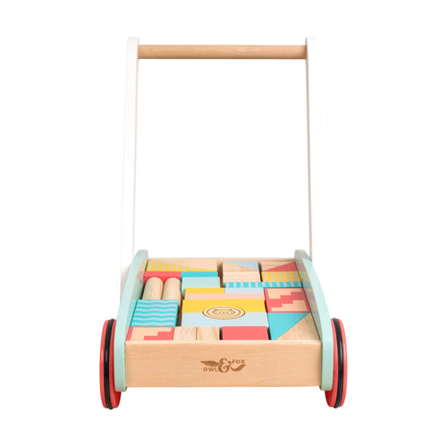 The TP Toys Owl & Fox Wooden Baby Walker and Blocks – FSC® certified – features a white handle, red wheels, and a tray of colorful geometric blocks for support and fun.