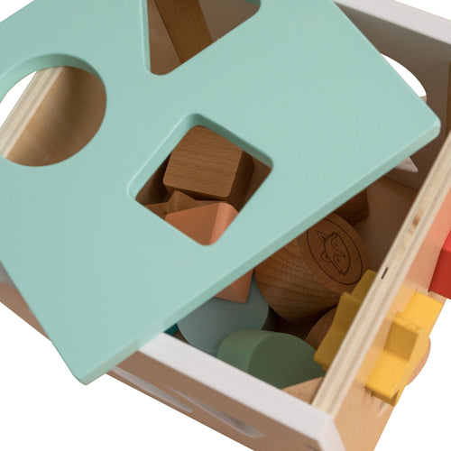 The TP Toys Owl & Fox Wooden Shape Sorter - FSC® certified features a mint green lid, partially open to reveal assorted wooden blocks inside the box.