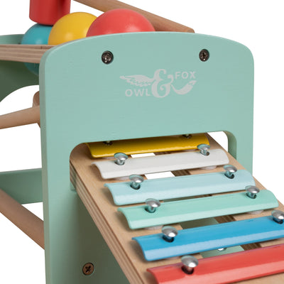 A close-up of the TP Toys Energetic Play Pack’s pastel Owl & Fox Xylophone—a wooden toy with metal keys and logo on the end, ideal for any toddler toys collection.