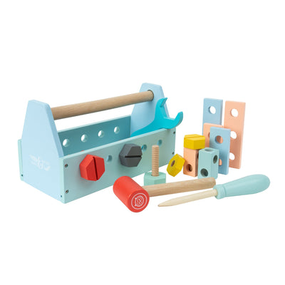 The TP Toys Owl & Fox Wooden Tool Caddy - FSC® certified includes a hammer, screwdriver, wrench, nuts, bolts, and colorful blocks for imaginative play, all neatly arranged beside a light blue caddy.