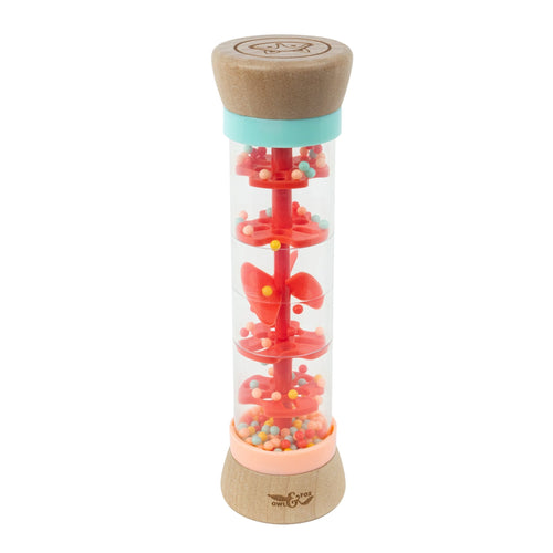 The TP Toys Owl & Fox Wooden Rainmaker - FSC® certified features clear plastic sides, wooden ends, red spinning paddles, and colorful beads—ideal for sensory development and musical play.