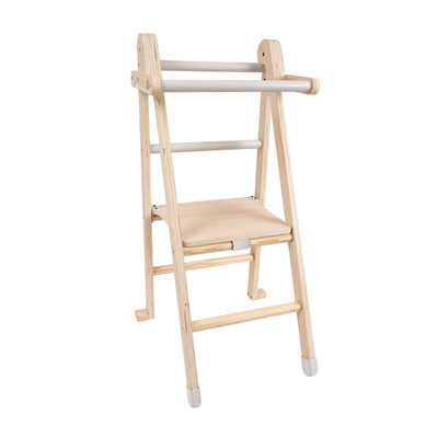 The TP Toys TP Active-Tots Pikler Style Wooden Folding Helper Tower is FSC® certified, features two steps, side handles, and has white-accented bars and foot pads for enhanced stability and support.